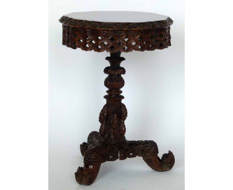 Burmese hardwood tripod table, the foliage circular tip-top on a an ornate column and tri-point base, diameter 52cm.