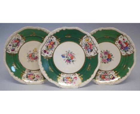 Three Rockingham plates circa 1830 painted with flora and an apple green border, puce marks to bases, (3) 26cm diameter Condi