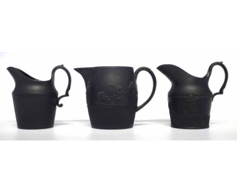 Three Black Basalt jugs circa 1800 one impressed Birch the other two attributed to Birch with the initials 'B' impressed on t