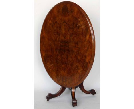 Victorian oval centre table, the figured walnut tip-top on a cluster column support and four out swept legs, 135cm.