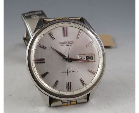 A vintage Seiko 5 sportsmatic with stainless case and two tone bracelet. The day date dial with brushed satin dial with baton