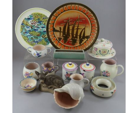 A group of largely 1960s Poole Pottery wares. To include: three jugs, two preserve pots, two plates, a shell-shaped dish, a b