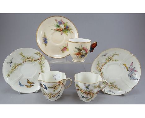 A Royal Worcester porcelain cup and saucer hand-painted with floral studies and a moulded handle in the form of a butterfly, 