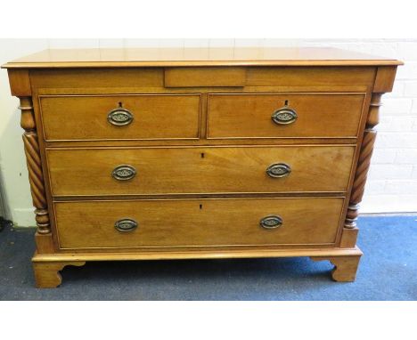 A Victorian mahogany low chest of two short over two long drawers with flanking twisted pilasters. Raised on bracket supports
