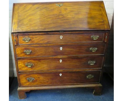 A George III mahogany full front writing bureau with simple fitted interior and four long drawers. Raised on bracket supports