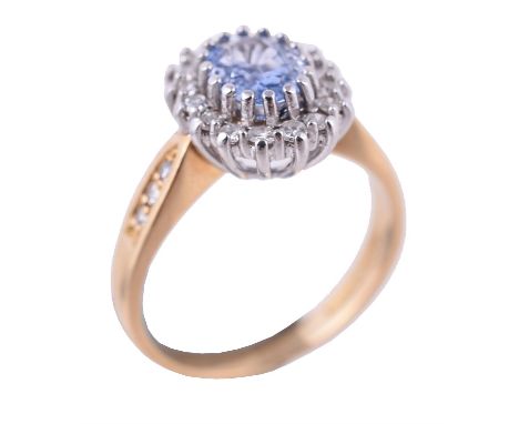 
	
		An 18 carat gold sapphire and diamond cluster ring, the oval cut sapphire within a surround of eight cut diamonds, to di