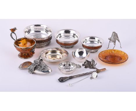 
	
		A collection of silver and silver coloured items, to include: a silver armada dish by Garrard &amp; Co. Ltd., London 200