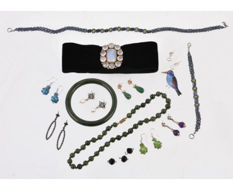 
	
		A polished nephrite bangle, inner diameter 6.6cm; a nephrite bead necklace, 43cm long; a pair of polished pear shaped av