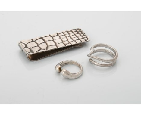 
	
		A dress ring by Georg Jensen, the looped wire ring stamped with makers mark, 750 and numbered 1314, finger size N 1/2, 8