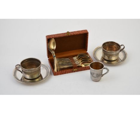 
	
		A pair of French silver coloured cups and saucers, .925 standard Minerva mark, the cups with scroll handles, lobed bands