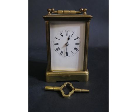 A Striking Brass Carriage Clock by R &amp; C. and with key, overwound, spring balance good, 16cm to top of handle 