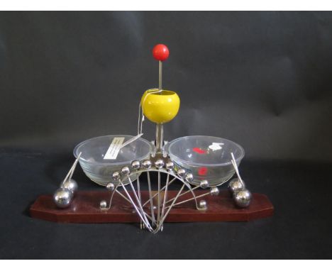 A Bonzer Serving Dish with push top opener and chrome pickle fork stand 