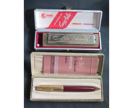 A Boxed Parker 51 with leaflet and Larry Adler Professional 12 harmonica 