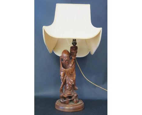 A Chinese Carved Wooden Immortal Table Lamp, 63cm inc. shade 