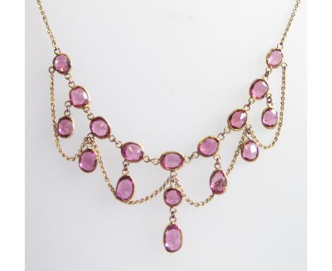 A Fringe Necklace set with garnets or amethyst in an unmarked gold setting, 37cm 