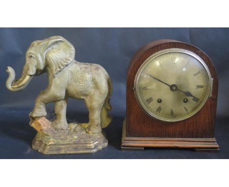 A Cast Iron Elephant Door Stop and damaged oak cased mantle clock 