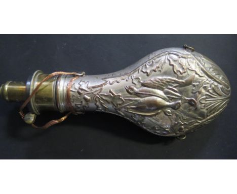 A Silvered Copper Powder Flask with game birds and foliate embossed decoration. 