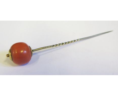 A 19th Century Coral Bead Stick Pin in a yellow metal setting, 9cm long, 6.5g 