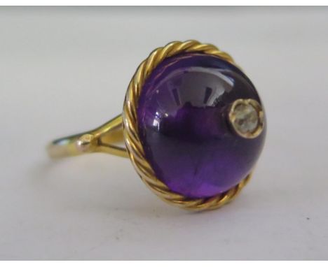 A Cabochon Amethyst and Diamond Ring in an unmarked gold setting, 17mm head, size N, 5.5g 