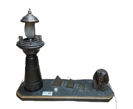 20th century table lamp in the form of a Lighthouse besides a Sphinx head and three graduated pyramids, L40cm 