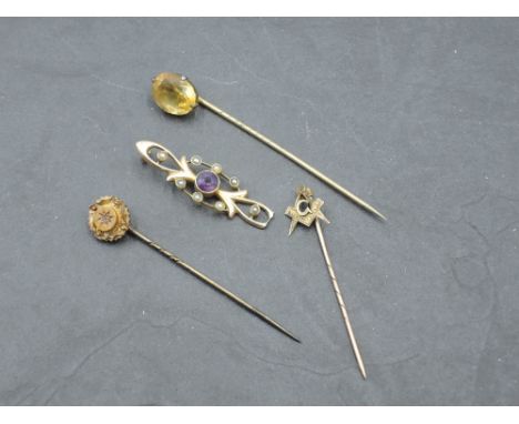 A 15ct gold amethyst and seed pearl bar brooch, damaged, 1.8grams sold along with a 9ct gold Masonic tie pin (bending to term