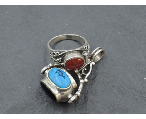An HM silver spin fob having four oval non precious stone panels, and a silver Artisan style dress ring having a hinged panel