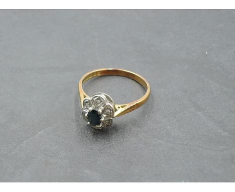 A sapphire and diamond chip cluster ring having an illusionary mount on an 18ct gold loop, size Q/R &amp; approx 3.8g