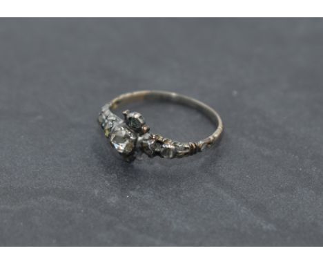 A Georgian diamond ring having a central rose cut diamond within a a surround of six further small rose cut diamonds in a fin