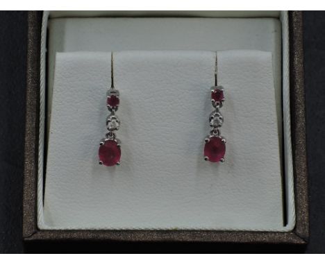 A pair of 18ct white gold stud earrings having a claw set ruby above  diamond and ruby drops, approx 1.6g