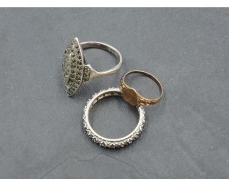 A small yellow metal signet ring stamped 9ct, a yellow metal full eternity ring having paste stones, no marks, and a white me