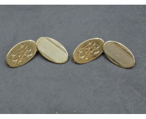 A pair of 9ct gold cufflinks having oval panels with engine turned decoration and monograms and chain connectors, approx 5g