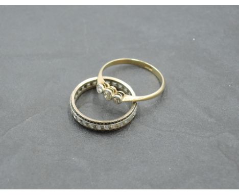 A diamond trilogy ring, total approx 0.15ct in collared mounts on a yellow metal loop stamped 18ct, size N/O &amp; 1.5g and a