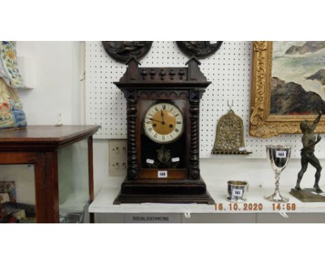 A Victorian mantle clock, working order, with pendulum and key