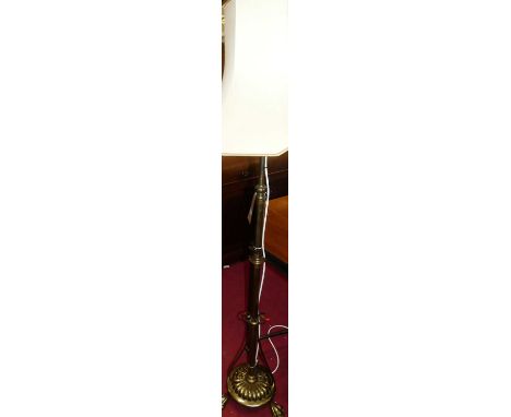 An Art Nouveau brass standard lamp with shade