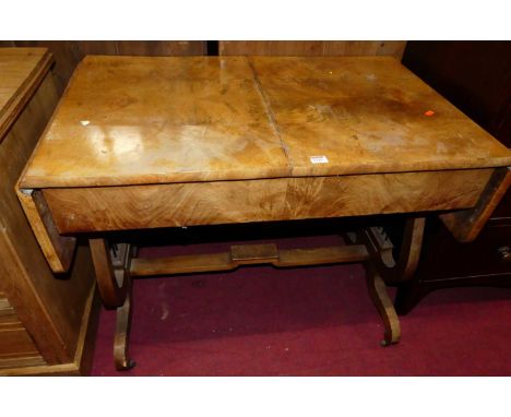 A German figured and faded mahogany drop flap sofa table, raised on shaped end supports, width (leaves down) 94cm