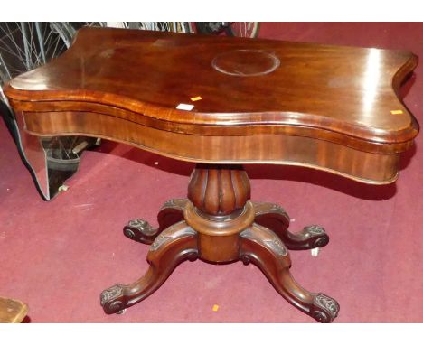 An early Victorian serpentine front mahogany fold-over baize lined card table, on bulbous reeded column to leaf capped suppor