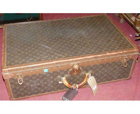 A canvas leather and brass bound travelling trunk, having monogrammed exterior, inner fabric lined removable tray, tan leathe