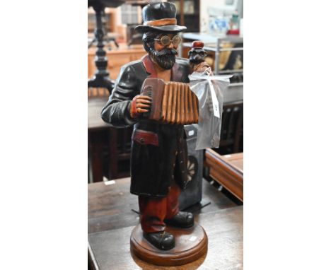 Carved and painted wood figure of a street musician with monkey and accordion, 64 cm 