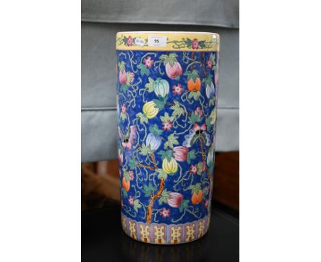 Chinese porcelain cylindrical stick stand with polychrome enamel melons and moths on a blue ground, 46 cm high (chip under ri