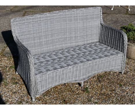 An all-weather grey wicker style two seat garden sofa, c/w cover and cushions