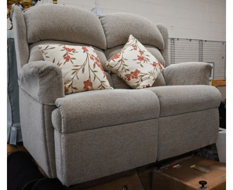 An oatmeal fabric two-seater sofa c/w pair of scatter cushions by Multiyork 