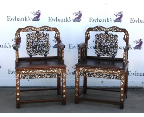 Pair of Chinese mother of pearl inlaid hardwood armchairs, the pierced floral design splats over solid seats and square legs 