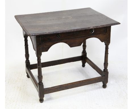 Late 17th/Early 18th century oak side table, the rectangular top with moulded edge over a frieze drawer and arched apron, on 