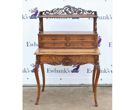 Victorian walnut writing table, the raised back with floral scroll gallery, shelf and four drawers over a leather lined slidi