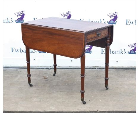 Regency crossbanded mahogany Pembroke table, with ebony stringing, the rounded leaves over a frieze drawer on ring turned tap
