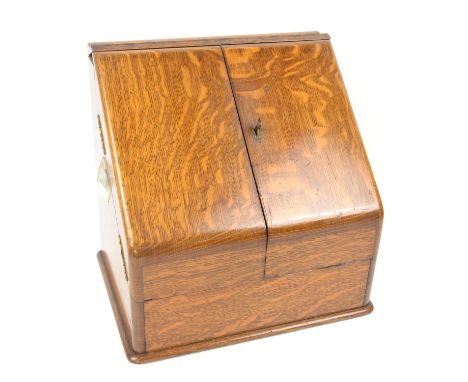 Late Victorian oak stationery box, the sloping twin doors enclosing a perpetual calendar and compartments, H32 W33 D24.5 cmCo