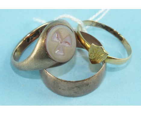 A 9ct gold signet ring set a hard stone cameo with propeller motif, size N, a small 18ct gold ring and a 9ct gold wedding ban