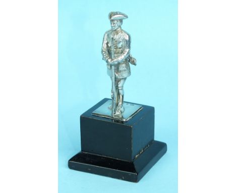 A small silver model of an 18th century Infantry man, London 1953, standing on wooden plinth, overall height 103mm.