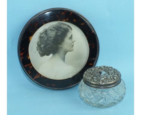 A small circular silver and tortoiseshell photograph frame, 12.25cm diameter, London 1918, (stand lacking) and a silver-toppe