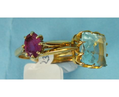 An 18ct gold ring claw-set an oval ruby, size L½, 2.4g, and an unmarked gold ring set pale blue stone, (a/f), size K, 2.8g, (